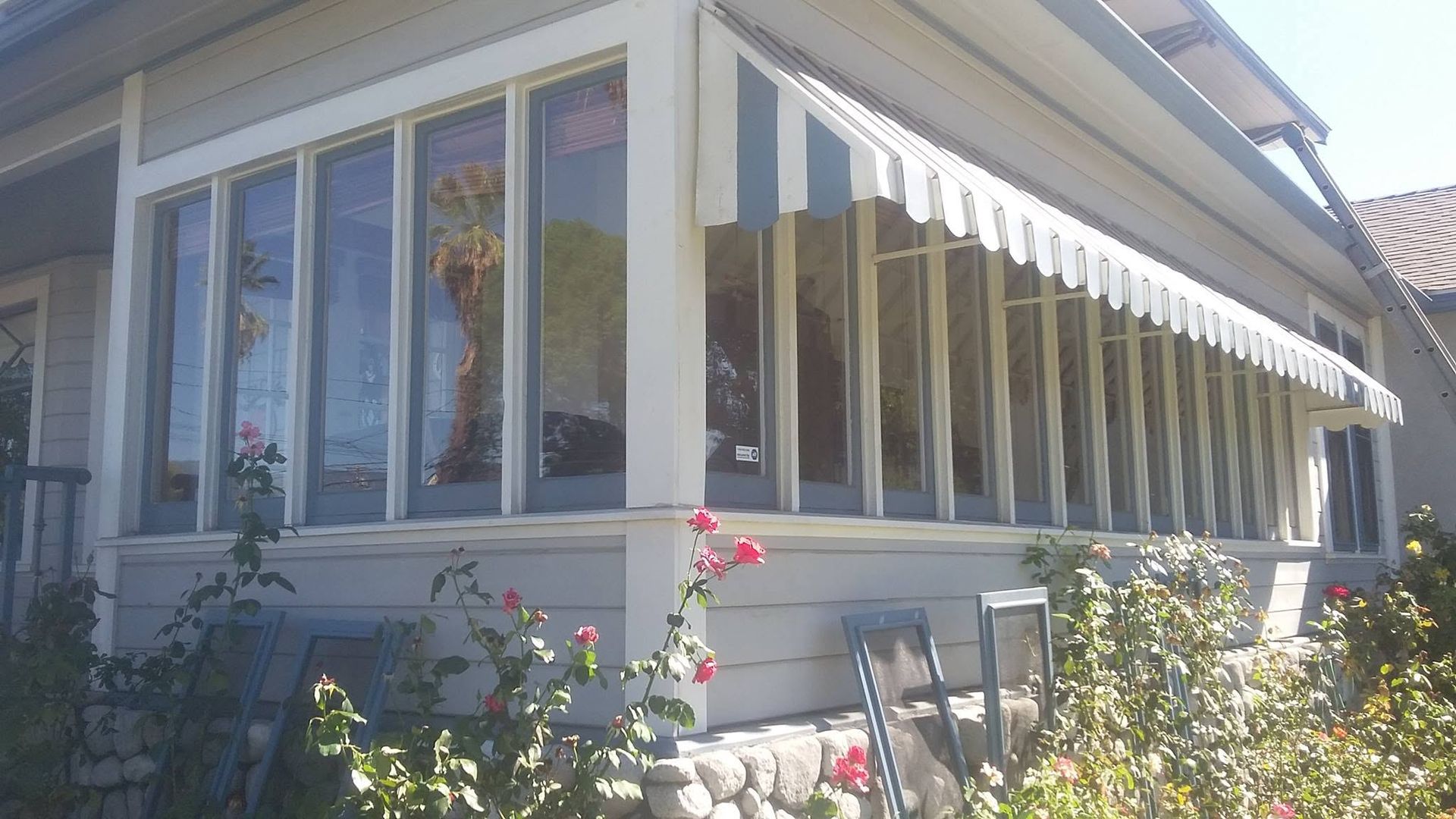 Window screens removed beside a sunroom during cleaning