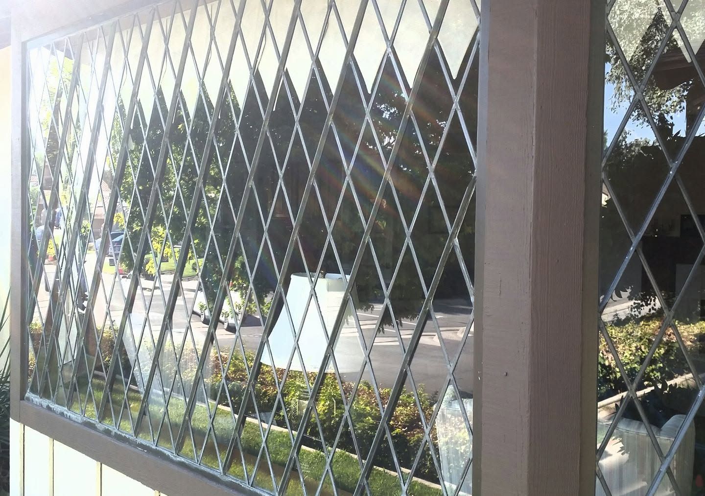 Sunlight shining through a clean window with a decorative security
grille