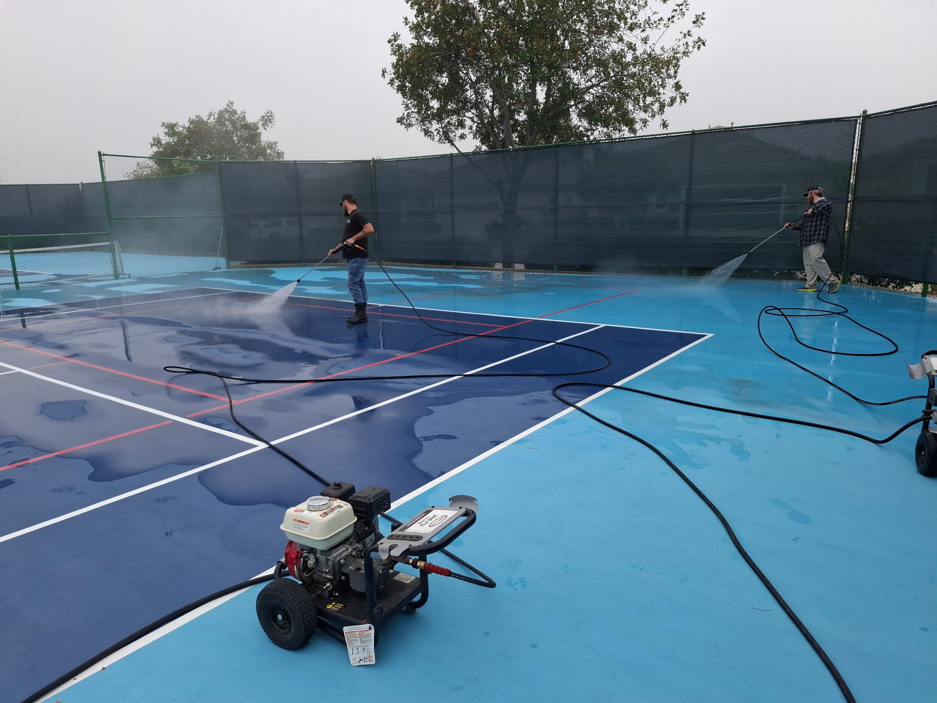 Bailey's Crew Pressure Washing a Tennis Court